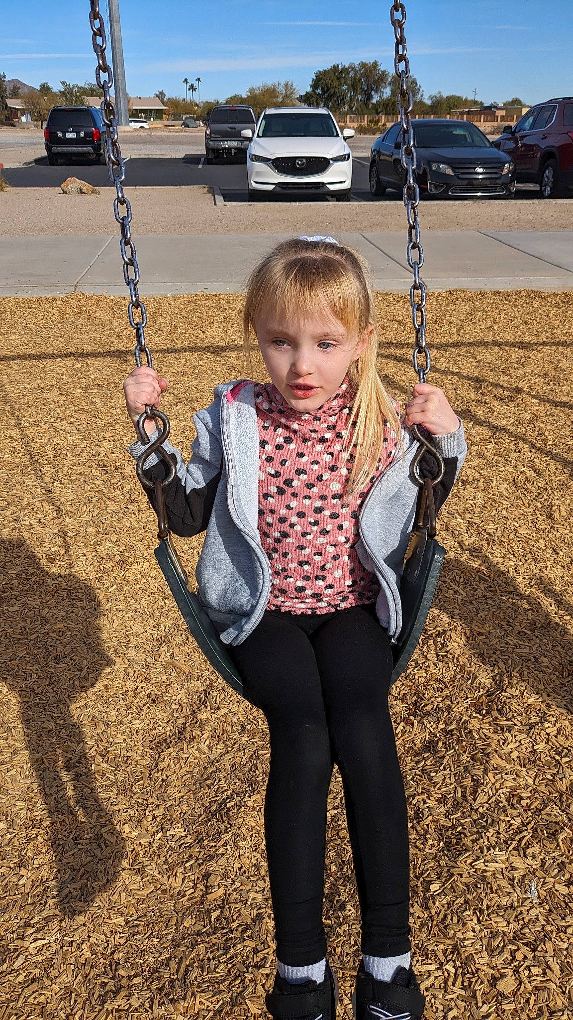 Kenzie joined the competition — help win amazing prizes! blond, car, child, city, fun, grass, happy, leisure, outdoor_play_equipment, person, plant, playground, recreation, sky, sleeve, soil, swing, tire, toddler, tree