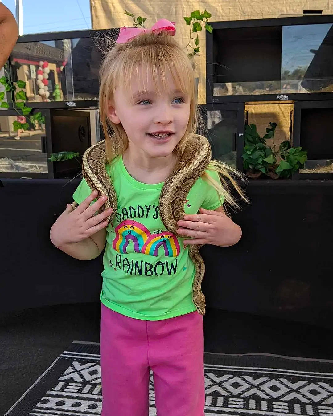 Kenzie is registered to the contest to win money with this photo: child, cool, fashion_accessory, fun, grass, happy, joy, leisure, party, pattern, person, pink, plant, play, sleeve, smile, t_shirt, television, thumb, toddler