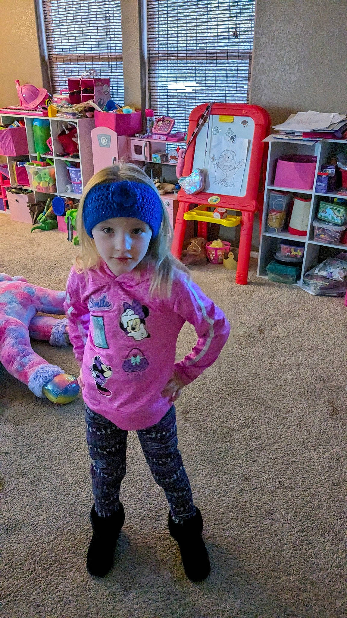 Kenzie is registered to the contest to win money with this photo: baby_toddler_clothing, boot, chair, child, fun, happy, headwear, kindergarten, leisure, magenta, pattern, person, pink, play, public_space, purple, room, shelf, shelving, sitting