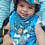 baby, child, smiling, hat, bucket_hat, blue_clothing, pacifier, plush_toy, elephant_toy, bandana, seated, closeup, cute, happy, infant, face, hand, striped_background, accessory, portrait