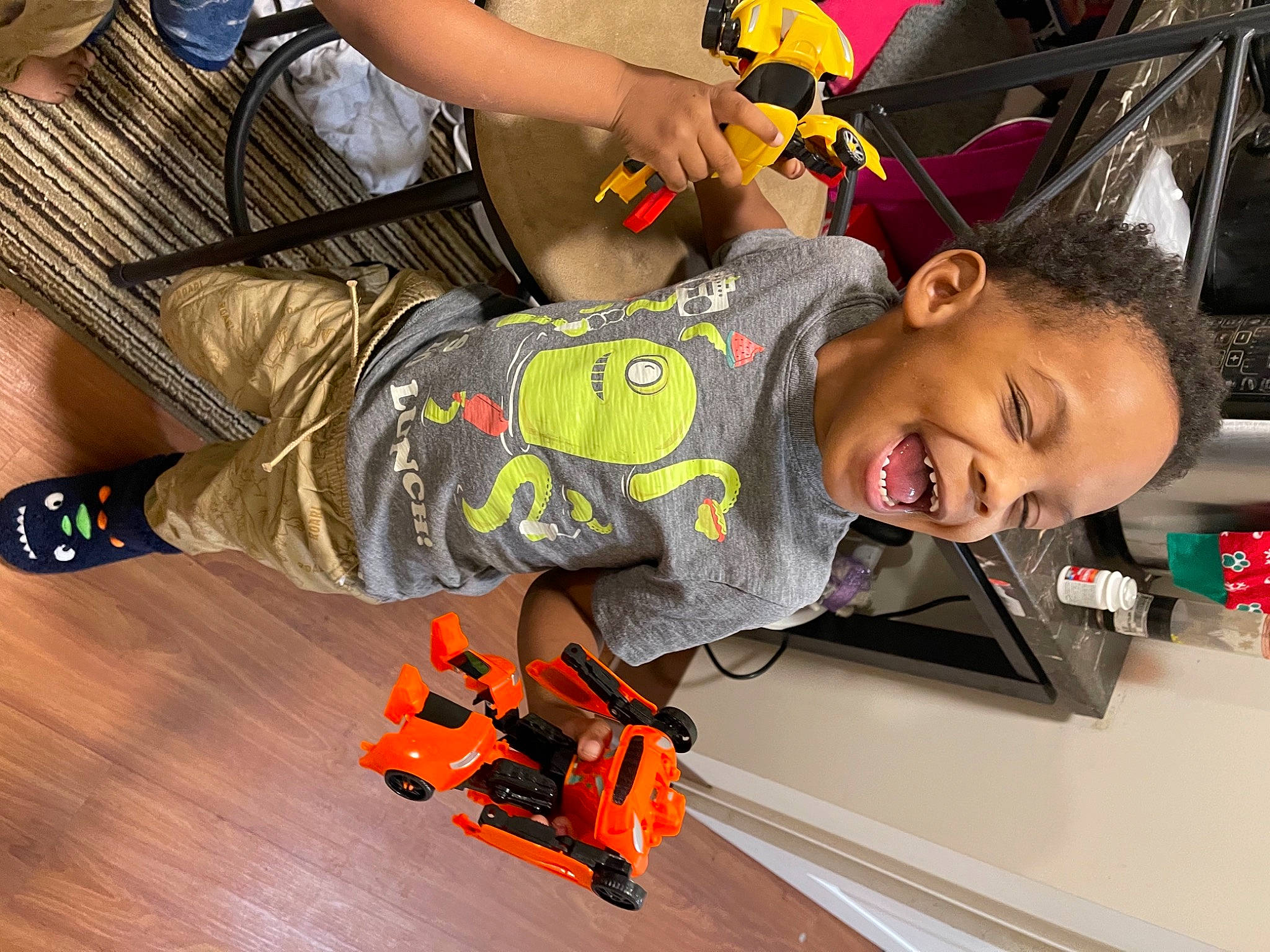 Dakari joined the competition — help win amazing prizes! bermuda_shorts, laminate_flooring, person, sandal, slipper, tooth, toy, varnish, walking_shoe, wood_flooring