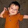 baby, infant, child, smile, face, eyes, hair, carpet, clothing, orange, cute, portrait, happy, skin, person, indoors, texture, button, sleeve, lying_down