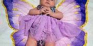 Adalyn is registered to the contest to win money with this photo: baby, infant, purple, butterfly, blanket, headband, dress, tulle, cute, portrait, child, lying_down, pattern, soft_texture, skin, small_hands, legs, indoors, colorful, adorable