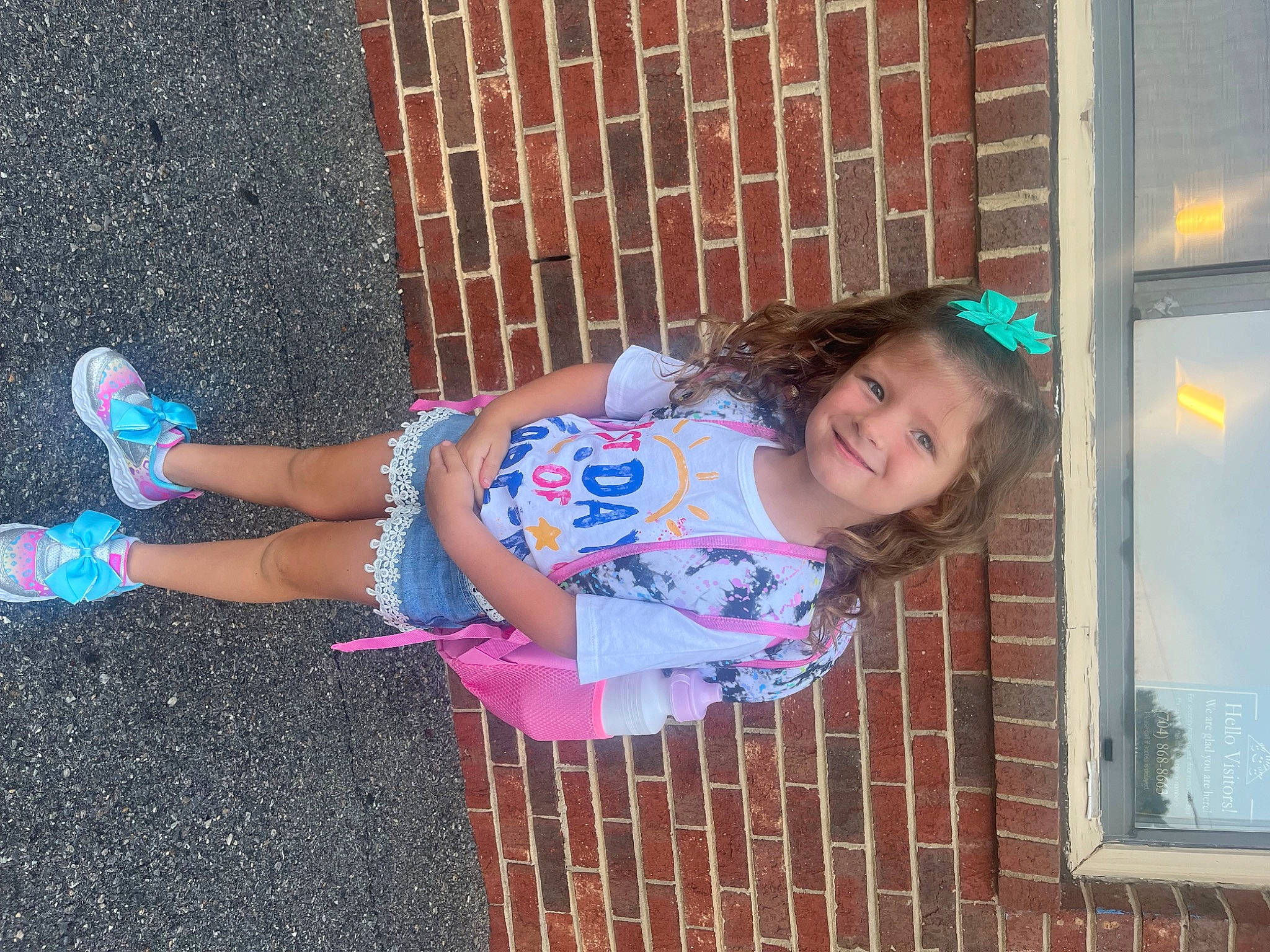 Macy is registered to the contest to win money with this photo: baby_toddler_clothing, beauty, child, dress, electric_blue, foot, fun, happy, human_leg, joy, leg, leisure, magenta, pattern, person, pink, sandal, smile, standing, thigh