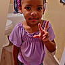 child, girl, toddler, portrait, smiling, happy, indoor, bathroom, purple_shirt, denim_shorts, hair_rollers, braids, hairstyle, hand_gesture, three_fingers, standing, sandals, white_socks, curtain, home