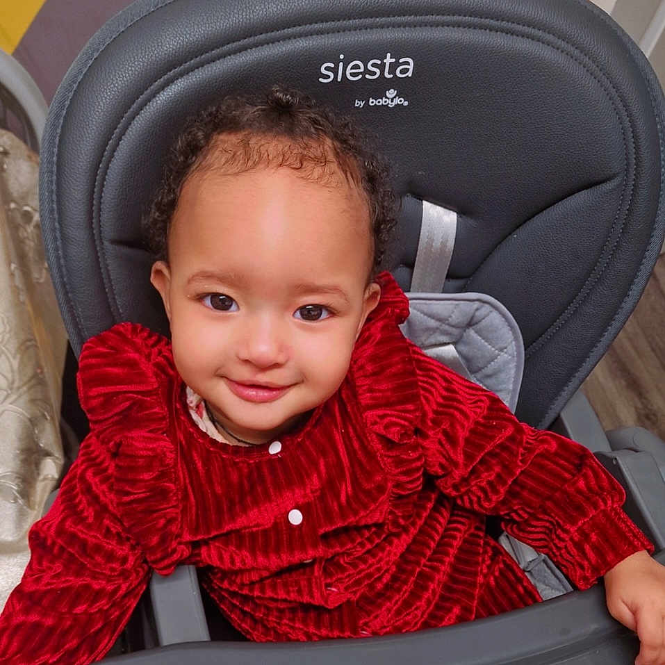 Adalia is registered to the contest to win money with this photo: baby, car, chair, clothing, coat, cushion, dress, face, furniture, happy, head, homedecor, jacket, person, photography, portrait, smile, transportation, vehicle, velvet