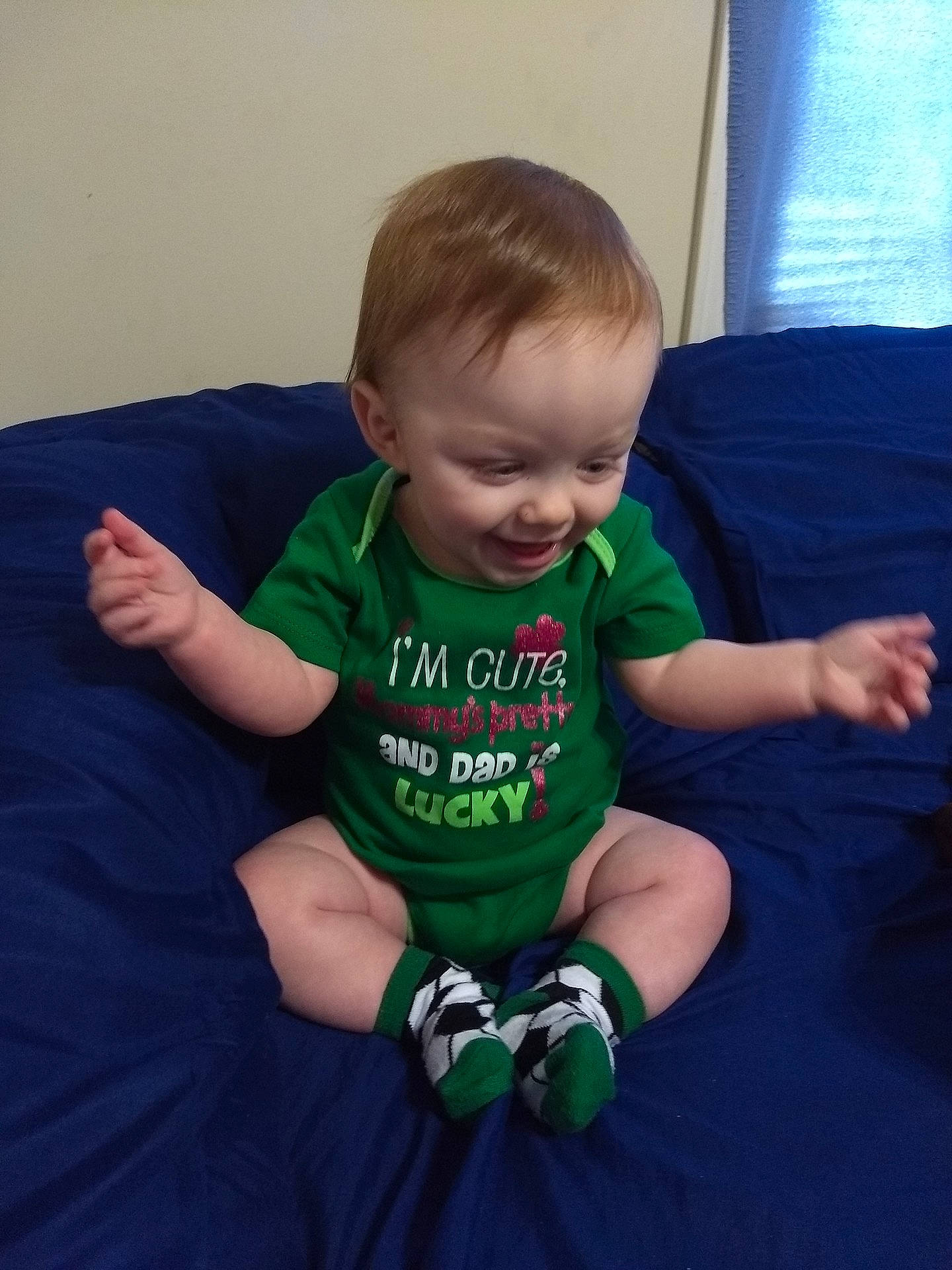 Thayer is registered to the contest to win money with this photo: arm, boy, child, day, finger, fun, green, infant, joy, person, play, product, sitting, smile, t_shirt, toddler