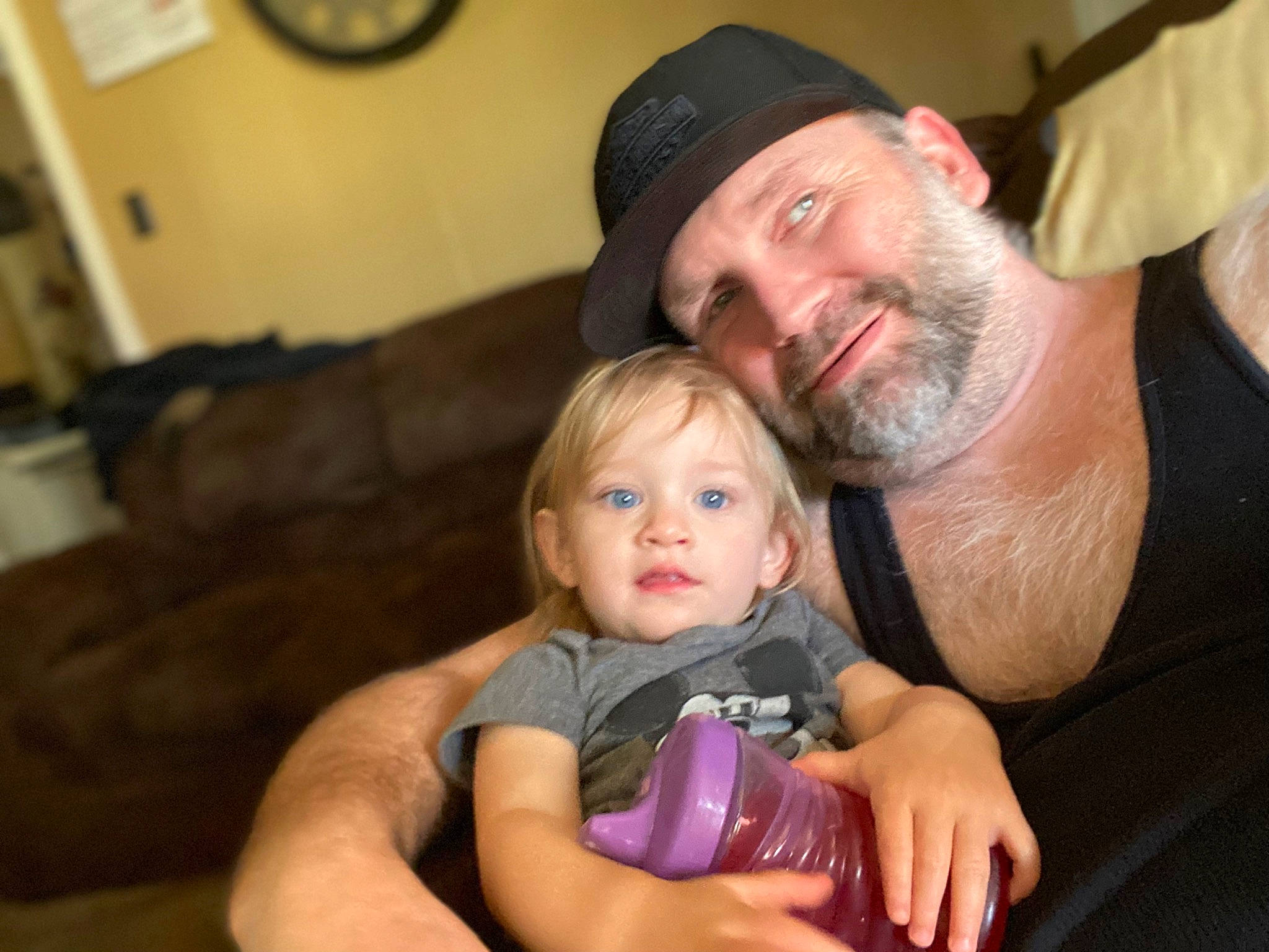 Laiah joined the competition — help win amazing prizes! baby, baseball_cap, beard, cap, child, clock, comfort, couch, event, face, facial_hair, fun, happy, headwear, joy, lap, mouth, muscle, person, sitting