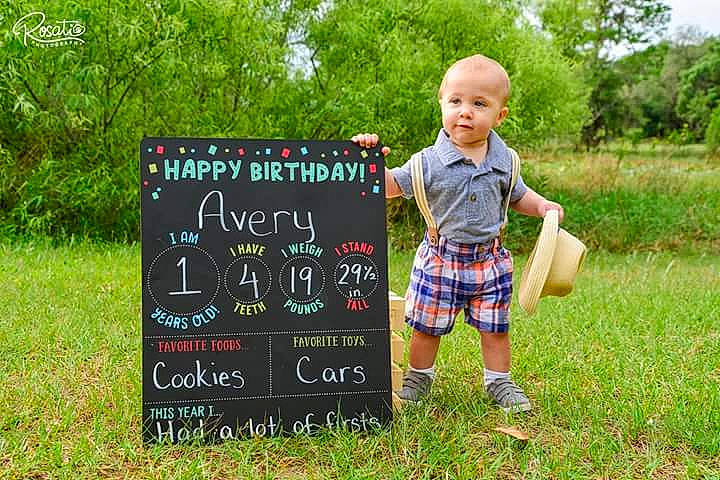 Avery joined the competition — help win amazing prizes! blackboard, child, grass, kilt, nature, pattern, person, plaid, plant, play, toddler, tree, wildflower