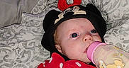 Oaklynn is registered to the contest to win money with this photo: baby, bottle, blanket, clothing, cute, face, hat, infant, lying_down, mickey_mouse, minnie_mouse, person, polka_dots, red, sleepwear, soft_toys, toddler, wearing_hat, white, young_child