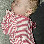 Oaklynn joined the competition — help win amazing prizes! baby, sleeping, pajamas, striped_clothing, couch, pillow, indoor, child, face, peaceful, infant, rest, cozy, home, soft_lighting, portrait, young_child, cute, relaxing, comfort