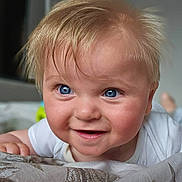 Ryan joined the competition — help win amazing prizes! baby, blanket, blonde_hair, blue_eyes, child, close_up, curious, cute, expression, face, hand, happy, indoor, infant, person, portrait, skin, smile, toddler, young_child