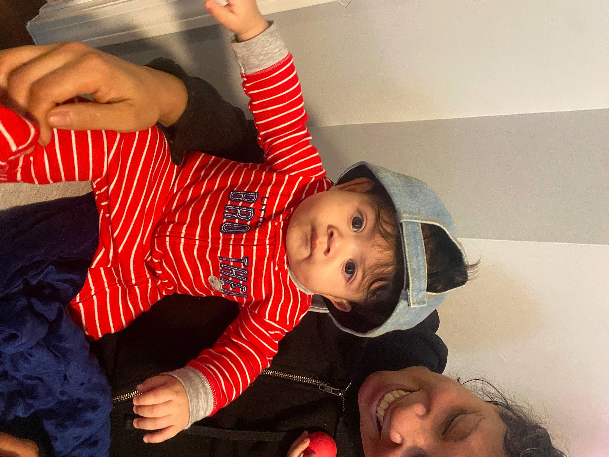 Azrael joined the competition — help win amazing prizes! arm, baby, baby_toddler_clothing, black_hair, child, comfort, couch, event, finger, fun, gesture, hand, happy, mouth, pattern, person, plaid, sitting, smile, snapshot