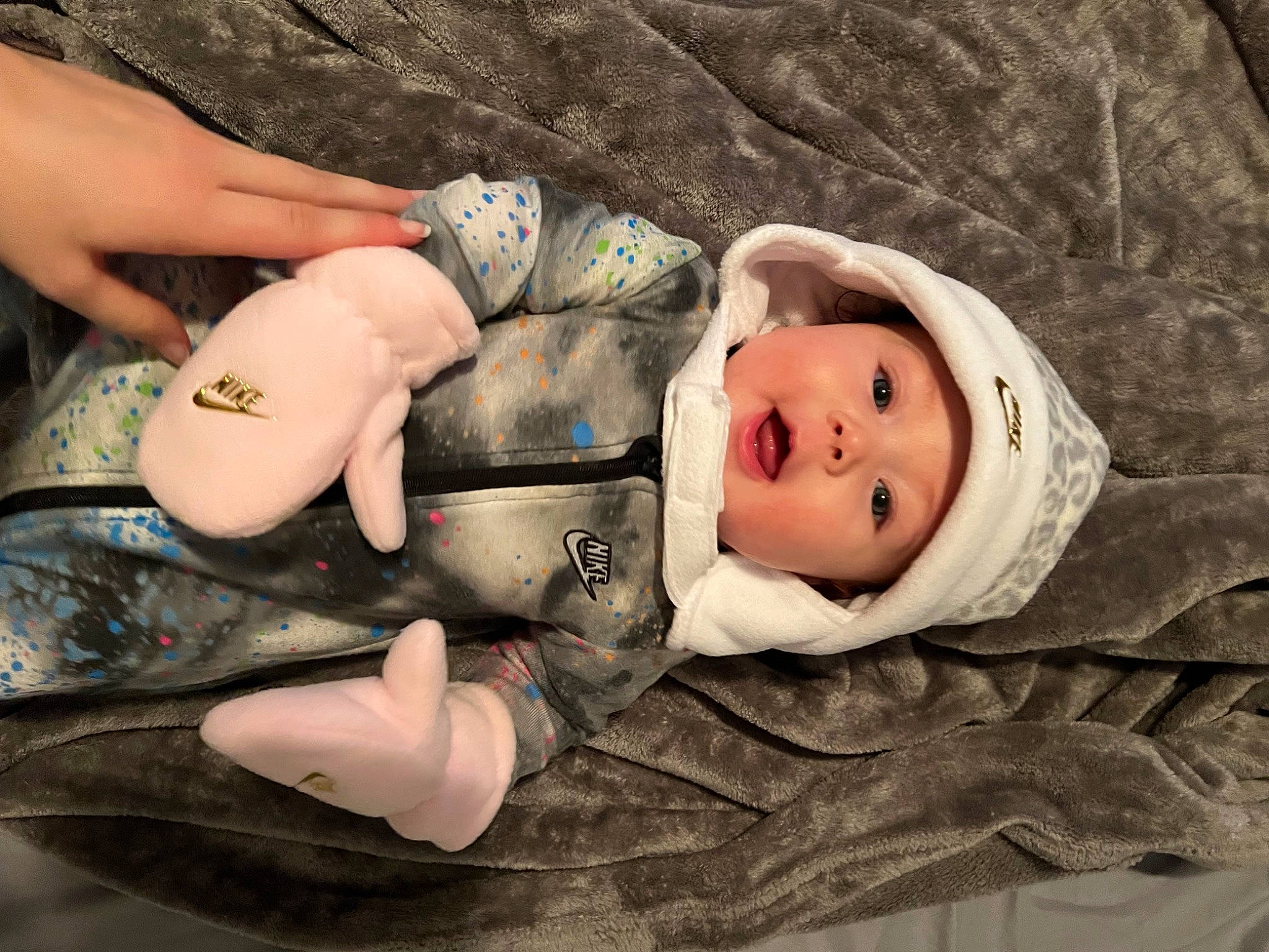 Ezra is registered to the contest to win money with this photo: baby, cheek, child, comfort, eye, eyelash, face, grass, head, headgear, headwear, human_body, human_leg, lip, person, sitting, skin, textile, thigh, toddler