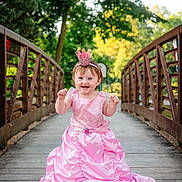 Paislyee joined the competition — help win amazing prizes! child, toddler, pink_dress, princess, crown, headband, bridge, wooden_bridge, outdoor, trees, greenery, happy, smiling, portrait, nature, daylight, cute, baby, person, fashion