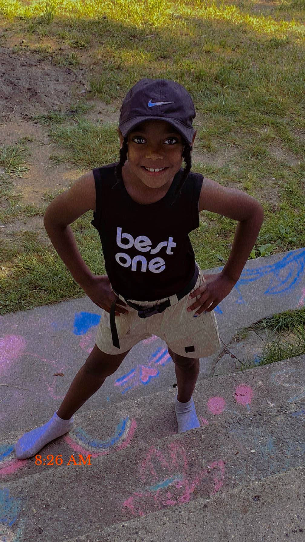 Leilani is registered to the contest to win money with this photo: athlete, baseball_cap, cap, child, exercise, fun, grass, happy, headwear, joy, leisure, magenta, person, recreation, running, shorts, sleeveless_shirt, smile, soil, sportswear