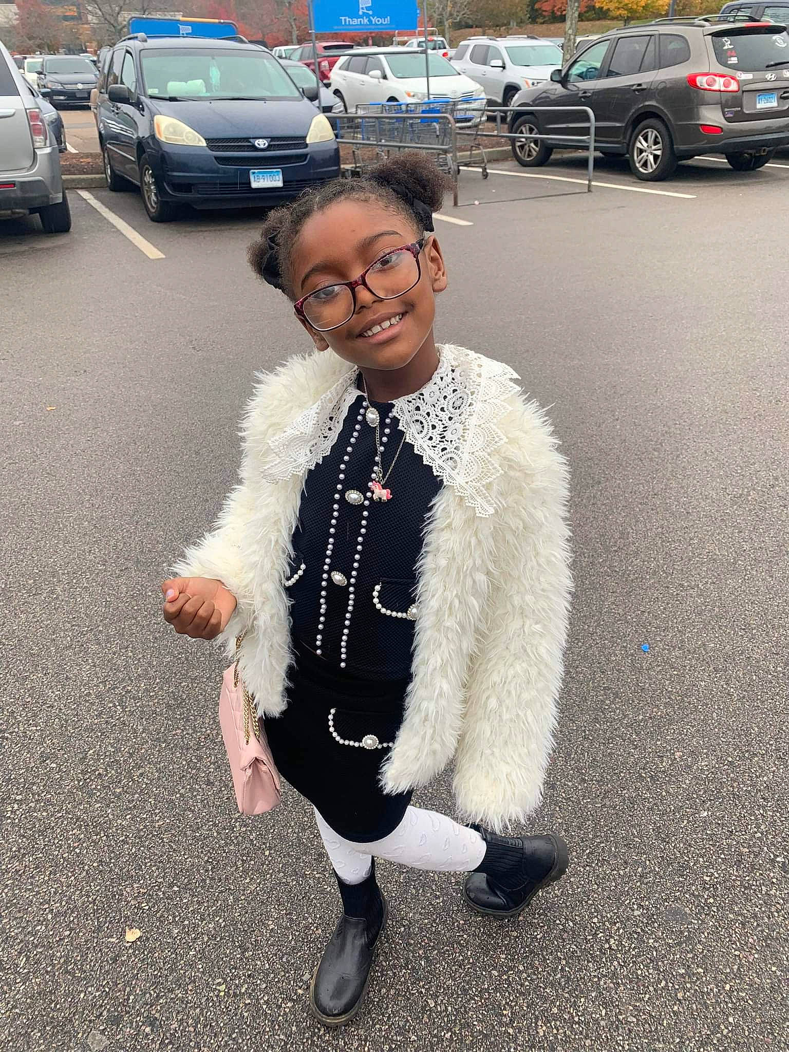 Leilani is registered to the contest to win money with this photo: asphalt, car, eyewear, family_car, fun, fur_clothing, gesture, glasses, joy, land_vehicle, motor_vehicle, parking, person, personal_luxury_car, road, road_surface, sidewalk, smile, tire, travel