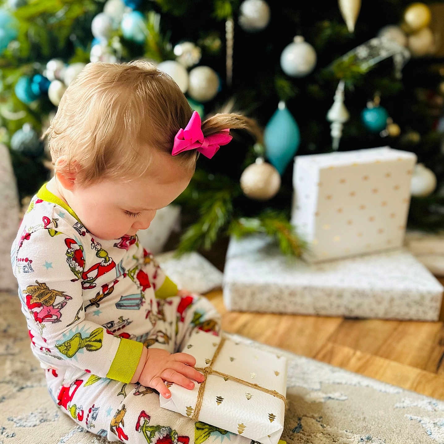 Leighla is registered to the contest to win money with this photo: accessories, baby, christmas, christmasdecorations, christmastree, face, festival, head, openingpresent, person, sitting, wallet