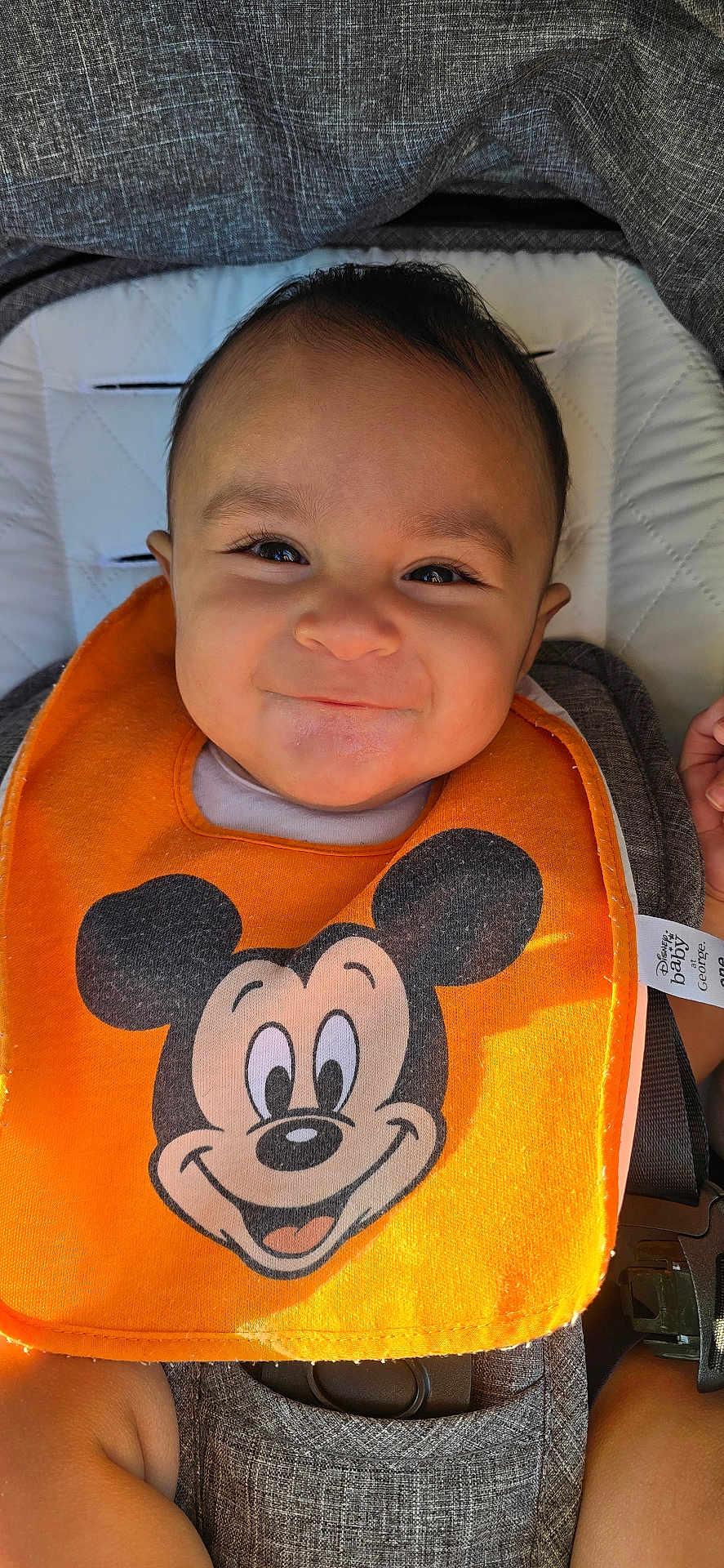 Qaelen joined the competition — help win amazing prizes! baby, baby_accessory, bib, car_seat, child, closeup, clothing, cute, fabric, face, happiness, indoor, infant, mickey_mouse, orange, person, portrait, seatbelt, smile, young_child