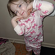 Daisy joined the competition — help win amazing prizes! child, pajamas, pink, bows, barefoot, indoor, floor, tile, towel, smile, pose, happy, person, cute, face, hair, long_sleeve, pants, blue_eyes, home