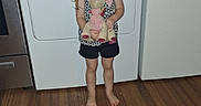 Daisy joined the competition — help win amazing prizes! child, girl, unicorn, plush_toy, laundry_room, dryer, washing_machine, barefoot, wooden_floor, smiling, standing, indoors, appliance, toy, person, cute, happy, home, casual, shorts