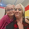 Lilly joined the competition — help win amazing prizes! child, woman, glasses, indoor, selfie, smile, person, face, hair, plaid_shirt, pink_clothing, braids, necklace, piercing, wall, ceiling, light, colorful_background, happy, casual