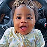 baby, infant, child, smiling, happy, car_seat, steering_wheel, bow, headband, curly_hair, floral_outfit, clothing, indoors, window, rain, portrait, face, cute, hands, person