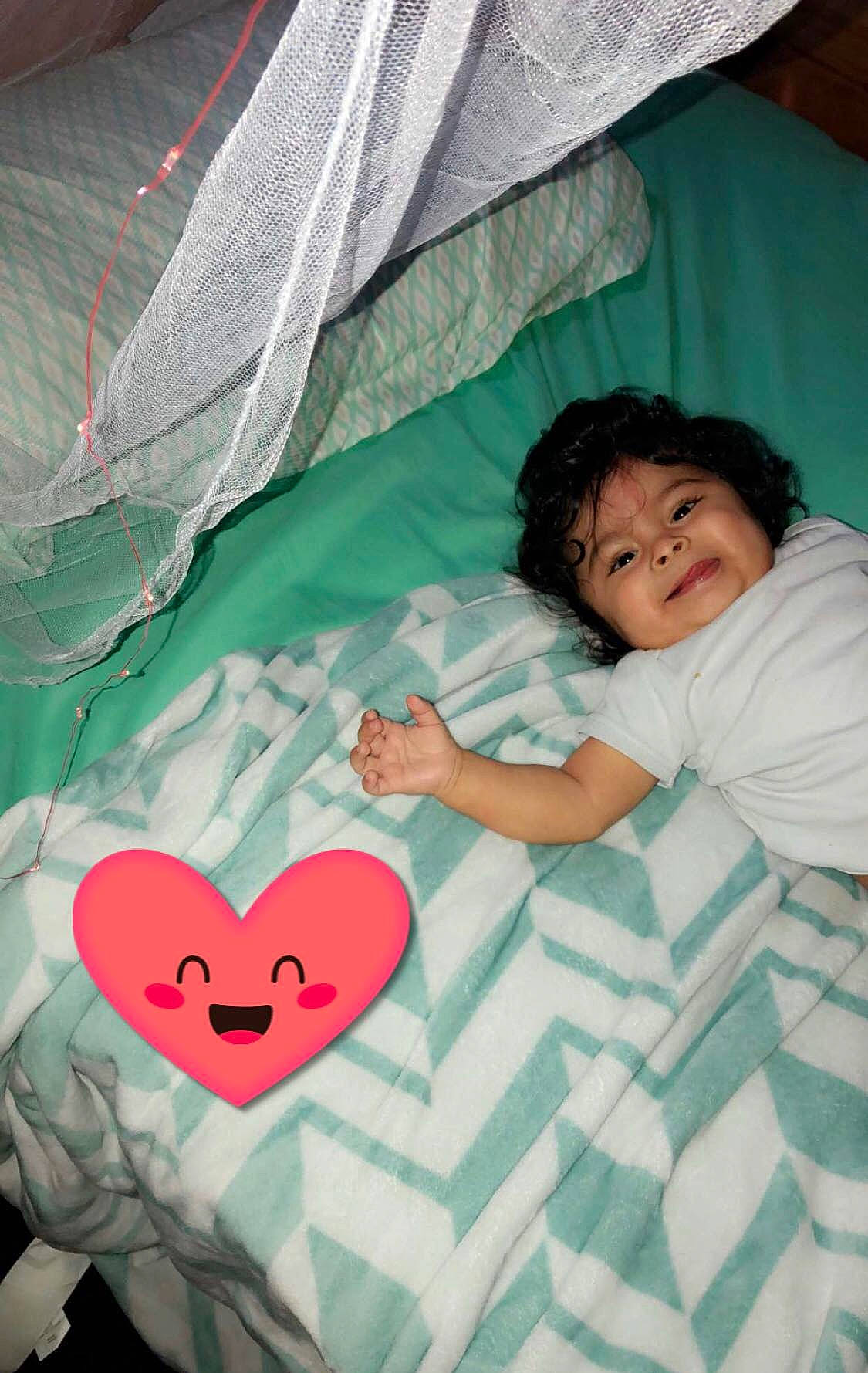 Davis is registered to the contest to win money with this photo: child, eye, fun, girl, green, human_body, infant, leisure, organ, person, pink, product, red, skin, smile, textile