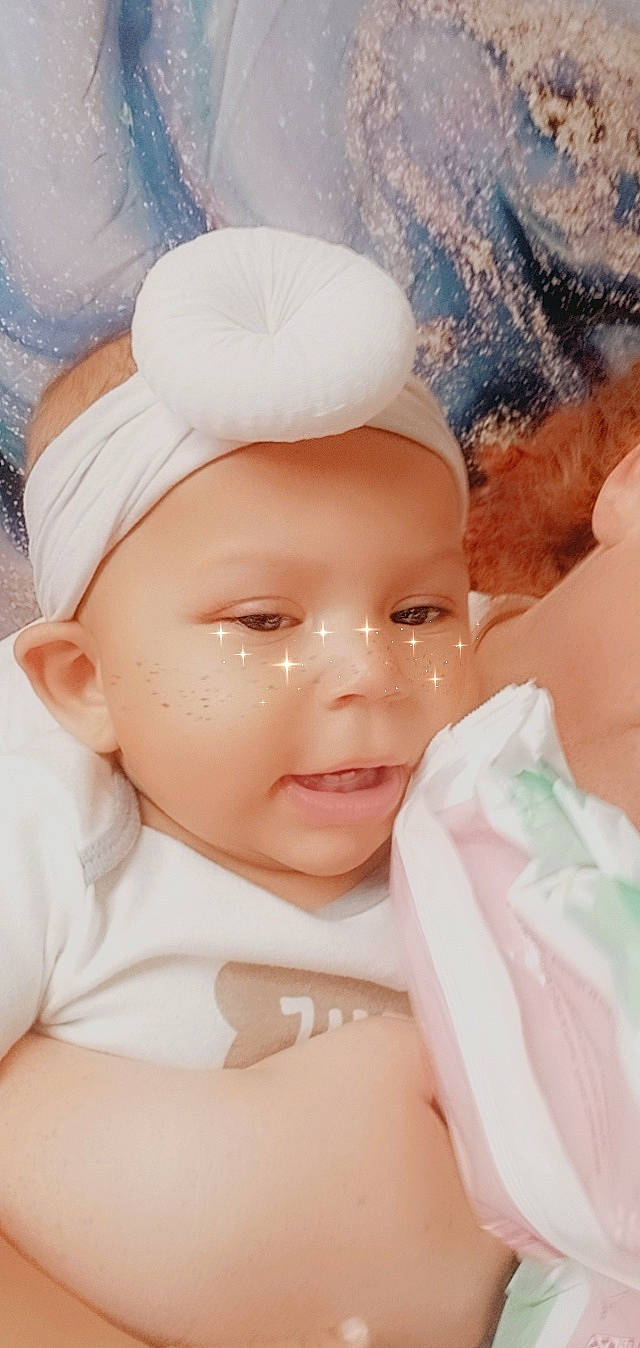 Kaleah is registered to the contest to win money with this photo: baby, baby_toddler_clothing, cap, cheek, child, eye, eyelash, fashion_accessory, fun, happy, headpiece, headwear, human_body, lip, mouth, nose, person, pink, skin, textile