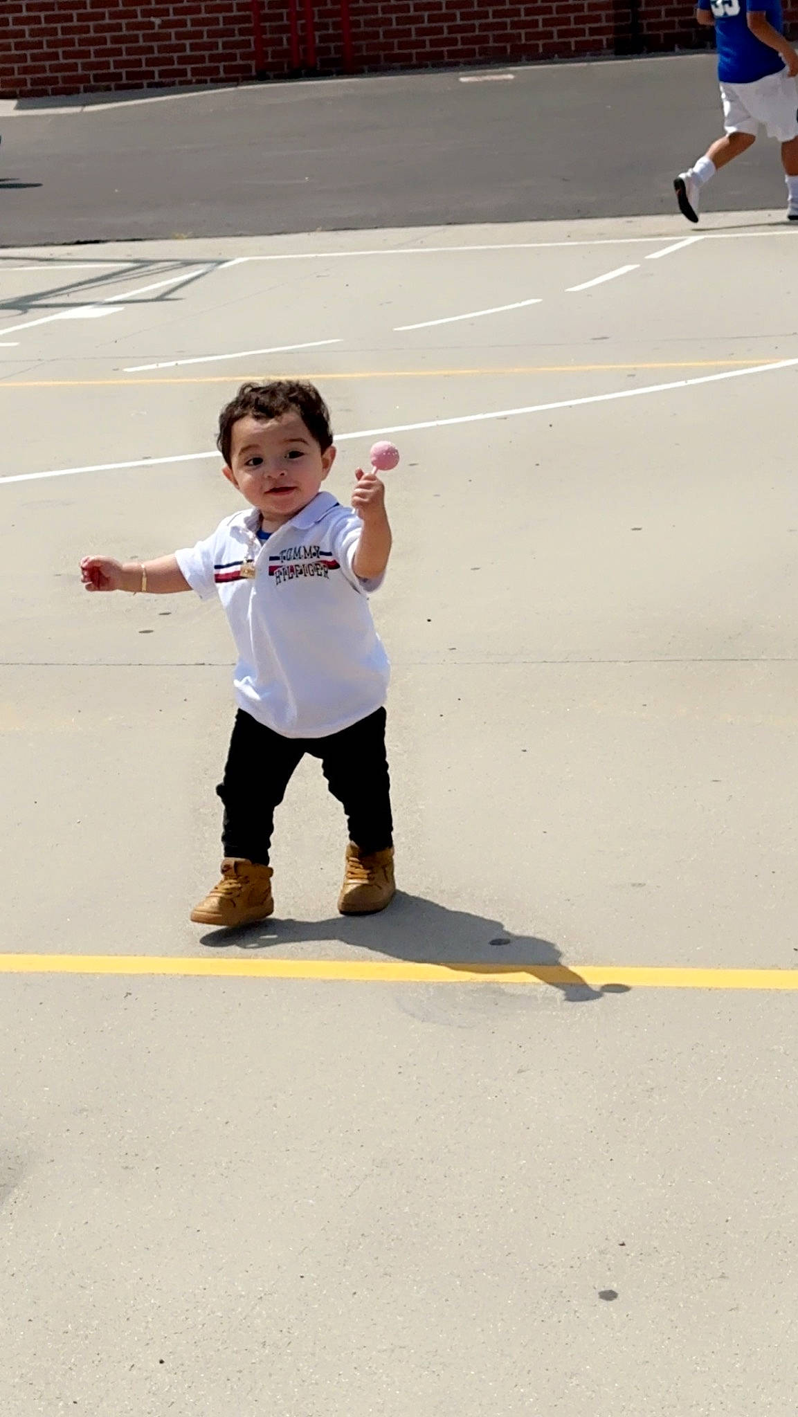 Josiah is registered to the contest to win money with this photo: asphalt, competition_event, fun, games, gesture, individual_sports, leisure, pedestrian, person, play, player, recreation, road, running, sand, shadow, sport_venue, sports, toddler, track_and_field_athletics