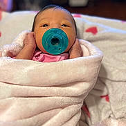 Rosalynn is registered to the contest to win money with this photo: baby, newborn, pacifier, blanket, pink, wrapped, infant, face, sleepy, indoors, soft, cute, child, person, hands, cozy, portrait, young, warm, resting