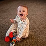 baby, carpet, child, colorful_toy, cute, face, feet, hands, happy, indoor, infant, laughing, playtime, polka_dot_pajamas, portrait, sitting, smiling, strawberry_slippers, toy, warm_lighting