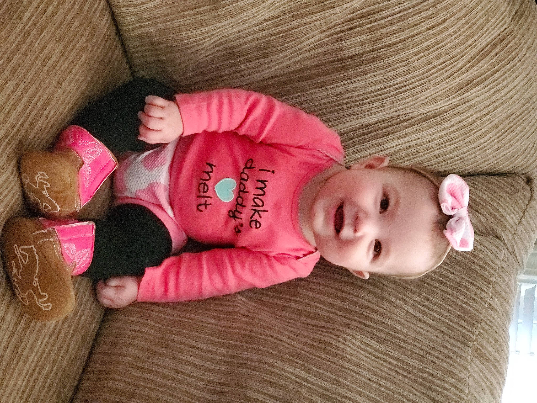 Rosalie is registered to the contest to win money with this photo: arm, baby_toddler_clothing, cheek, comfort, finger, floor, hand, head, headgear, human_body, iris, joy, leg, mammal, nose, person, pink, product, skin, sleeve