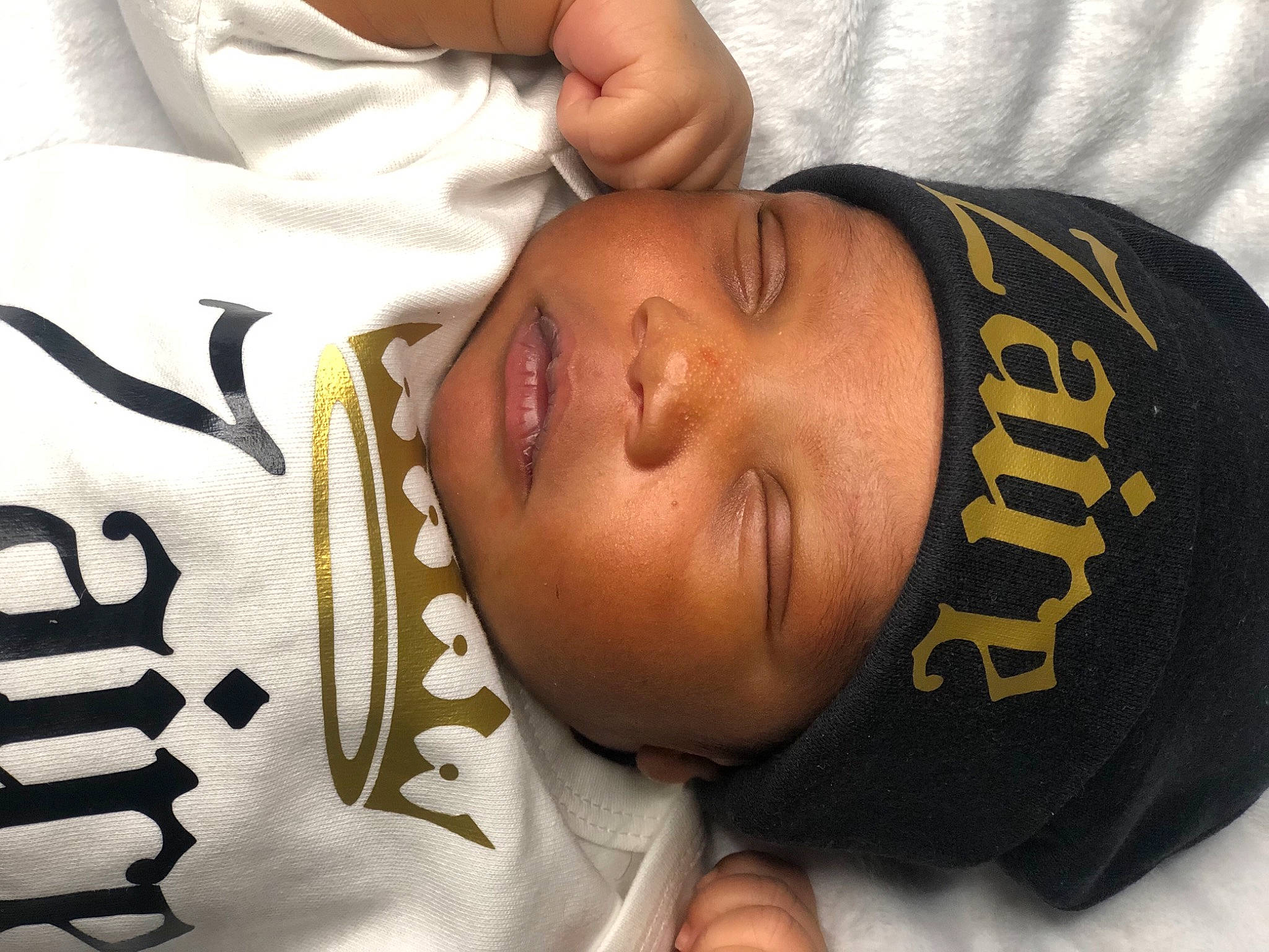 Zaire is registered to the contest to win money with this photo: abdomen, arm, chest, child, comfort, elbow, eyelash, finger, gesture, hand, happy, head, headwear, human_body, neck, nose, pattern, person, sleeve, thumb