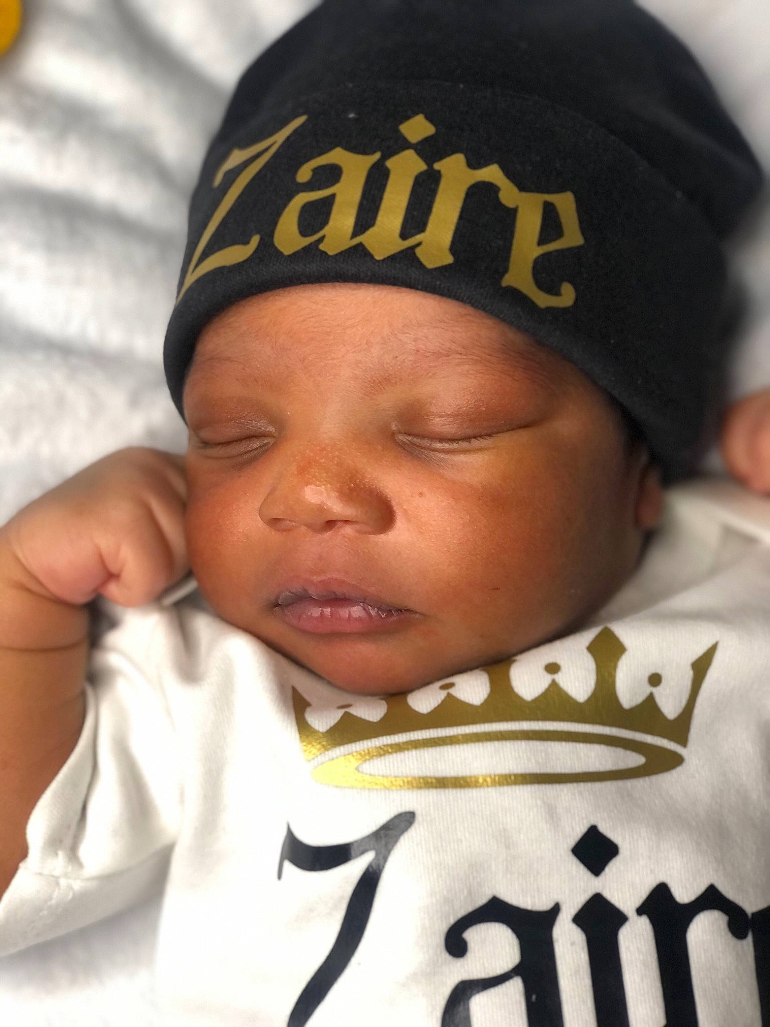 Zaire is registered to the contest to win money with this photo: baby, baby_sleeping, cap, cheek, comfort, eye, eyebrow, finger, forehead, gesture, happy, head, headgear, headwear, lip, mouth, person, photograph, sleeve, thumb