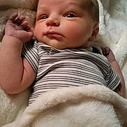 Colton joined the competition — help win amazing prizes! newborn, baby, infant, blanket, striped_onesie, soft, cozy, sleepwear, cute, face, arm, hand, skin, portrait, lying_down, warm, comfort, indoor, child, resting