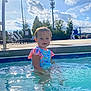 Elly May joined the competition — help win amazing prizes! toddler, child, pool, water, swimsuit, outdoor, sunny, sky, clouds, trees, fence, chair, concrete, daylight, summer, play, fun, person, young_child, recreation