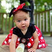 Elly May is registered to the contest to win money with this photo: baby, child, crawling, red_dress, polka_dots, headband, minnie_mouse, costume, outdoor, wooden_deck, hand, face, expression, curious, cute, person, nature, greenery, soft_focus, playful