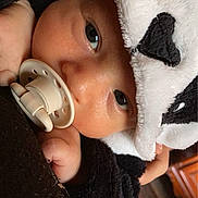 Zahir participe au concours pour gagner de l'argent avec cette photo : baby, pacifier, panda_hood, blanket, face, infant, cute, child, soft_texture, warm_lighting, close_up, portrait, hooded_clothing, black_and_white, hand, cozy, indoor, sleepy, comfort, toddler