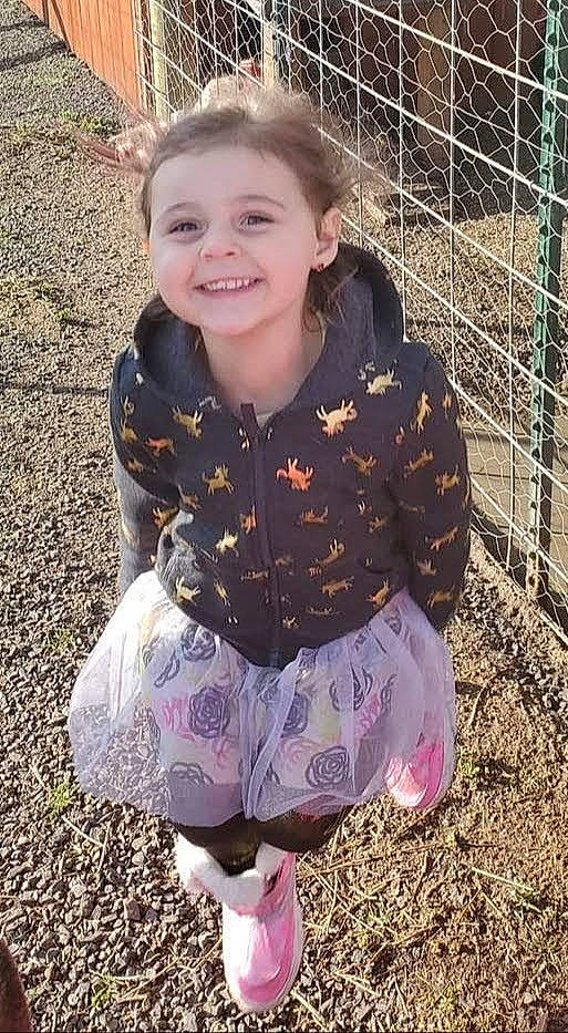 Morgana is registered to the contest to win money with this photo: baby_toddler_clothing, child, cool, eye, face, fawn, fence, grass, hair, happy, head, joy, mesh, people_in_nature, person, pink, purple, sleeve, smile, t_shirt