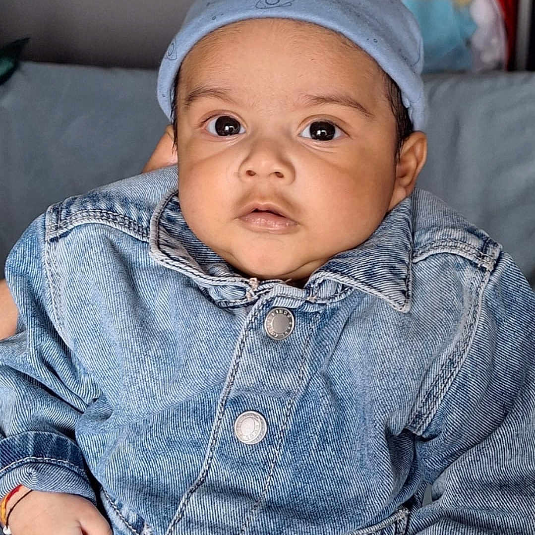 Arka is registered to the contest to win money with this photo: apparel, baby, casual, child, closeup, clothing, cute, denim_jacket, expression, eyes, face, fashion, hand, hat, indoor, infant, person, portrait, skin, young_child