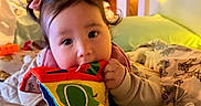 Faith is registered to the contest to win money with this photo: baby, bed, blanket, child, colorful_book, comfort, cozy, cute, fabric_book, home, indoors, person, pigtails, portrait, resting, sleepwear, soft_lighting, toddler, toy, young_child