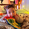 baby, bed, blanket, child, colorful_book, comfort, cozy, cute, fabric_book, home, indoors, person, pigtails, portrait, resting, sleepwear, soft_lighting, toddler, toy, young_child