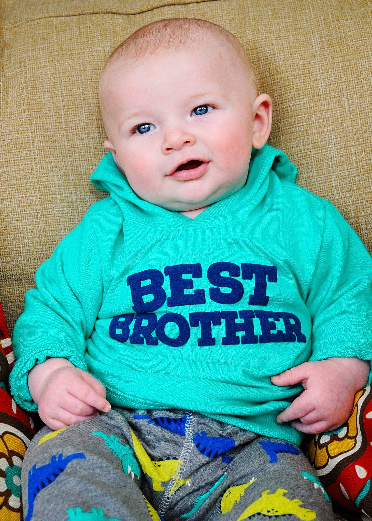 Lochlan is registered to the contest to win money with this photo: baby, baby_products, baby_toddler_clothing, blue, cheek, child, green, person, product, sitting, skin, sleeve, smile, t_shirt, toddler, turquoise