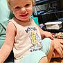 Weston joined the competition — help win amazing prizes! toddler, child, smiling, indoor, tank_top, person, sitting, floor, toy, shelf, controller, box, casual, happy, cute, blond_hair, shorts, barefoot, hand, home