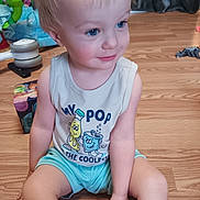 Weston joined the competition — help win amazing prizes! toddler, child, sitting, blue_eyes, blonde_hair, tank_top, shorts, indoor, wooden_floor, toys, smiling, cute, playful, person, young_child, floor, casual_clothing, happy, home, daylight