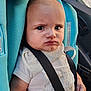 Isaac participe au concours pour gagner de l'argent avec cette photo : baby, car_seat, seatbelt, bib, infant, child, person, clothing, car_interior, expression, serious, sitting, safety, closeup, face, portrait, hands, blue, white, fabric