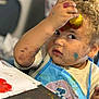 Ezekiel participe au concours pour gagner de l'argent avec cette photo : toddler, child, paint, art, craft, messy, curly_hair, apron, face_paint, hand_paint, table, paper, colorful, indoor, expression, young_child, creativity, play, mess, painting