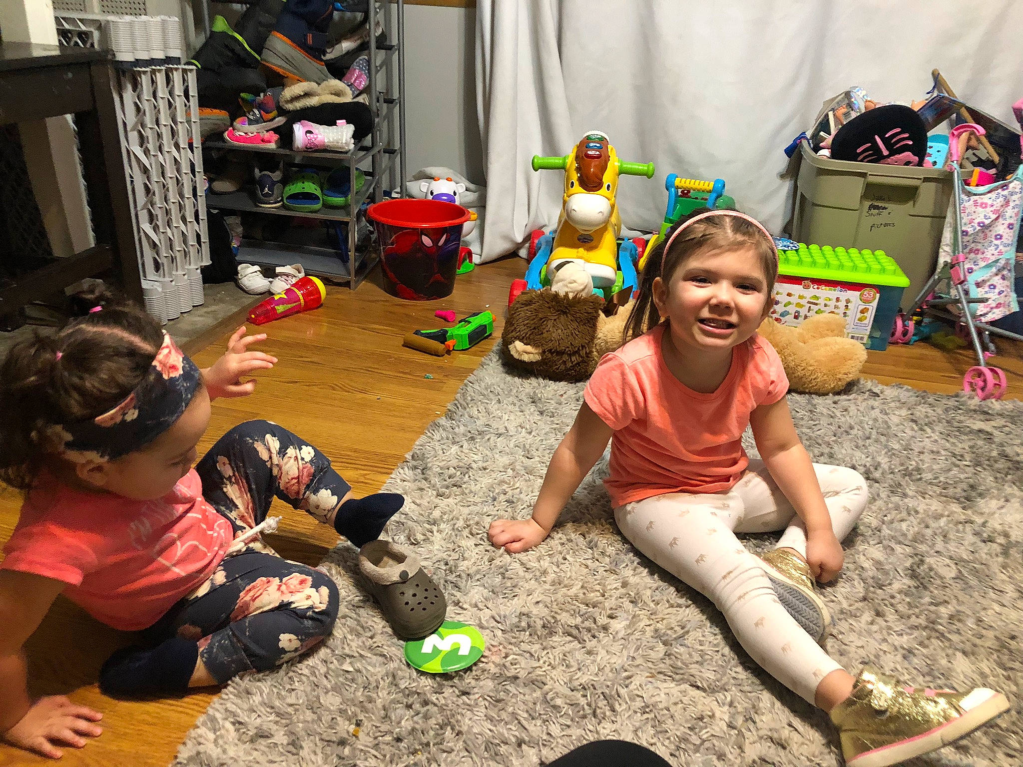 Veda is registered to the contest to win money with this photo: boot, child, event, flooring, fun, grass, green, happy, joy, kindergarten, leg, leisure, party, person, play, recreation, shorts, sitting, sneakers, soil