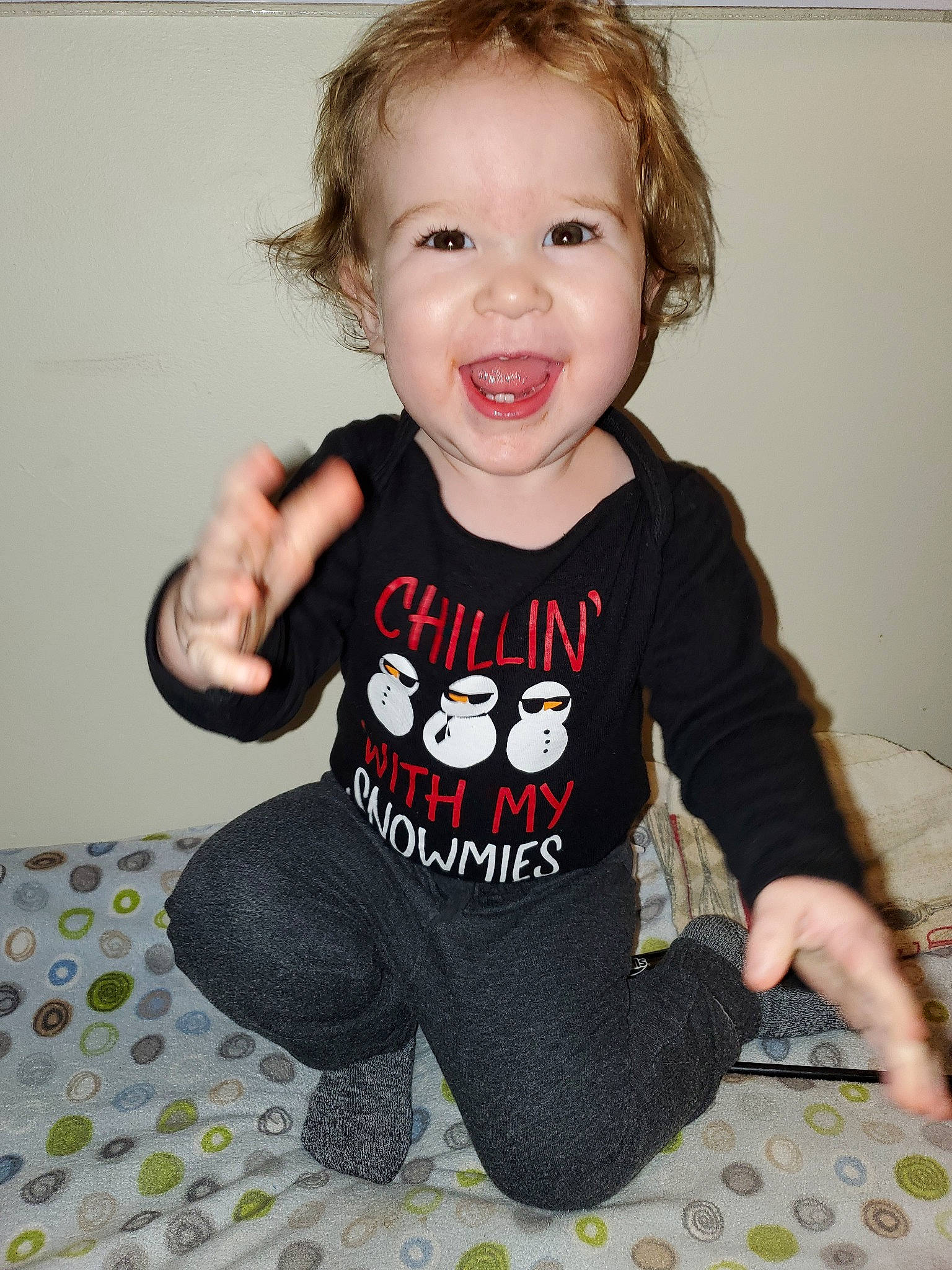 Greyson is registered to the contest to win money with this photo: baby, baby_products, baby_toddler_clothing, cheek, child, clothing, face, fictional_character, head, pattern, person, product, sitting, skin, sleeve, smile, t_shirt, toddler, top